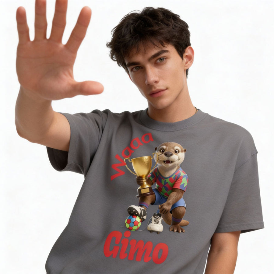 Young male wearing a t-shirt with a cartoon otter football  character holding football championship cup.